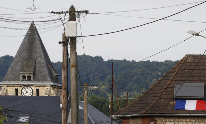 A French flag is seen on a rooftop near the bell tower of the church after a hostage-taking in Saint-Etienne-du-Rouvray near Rouen in Normandy, France, July 26, 2016. A priest was killed with a knife and another hostage seriously wounded in an attack on a church that was carried out by assailants linked to Islamic State. REUTERS/Pascal Rossignol A French flag is seen on a rooftop near the bell tower of the church after a hostage-taking in Saint-Etienne-du-Rouvray near Rouen in Normandy, France, July 26, 2016. A priest was killed with a knife and another hostage seriously wounded in an attack on a church that was carried out by assailants linked to Islamic State. REUTERS/Pascal Rossignol