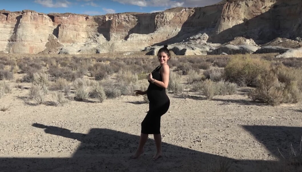 <strong>VISER MAGEN:</strong> Kylie poserer i ørkenen i en sort kjole som viser frem den voksende magen. Foto: Skjermdump Kylie Jenner/ YouTube <strong>VISER MAGEN:</strong> Kylie poserer i ørkenen i en sort kjole som viser frem den voksende magen. Foto: Skjermdump Kylie Jenner/ YouTube