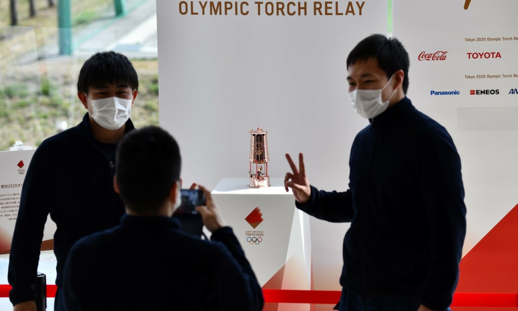 People take pictures of the Olympic Flame which was passed from Tokyo 2020 to Fukushima Prefecture at the J-Village National Training Centre in Naraha on April 2, 2020. (Photo by Kazuhiro NOGI / AFP) People take pictures of the Olympic Flame which was passed from Tokyo 2020 to Fukushima Prefecture at the J-Village National Training Centre in Naraha on April 2, 2020. (Photo by Kazuhiro NOGI / AFP)
