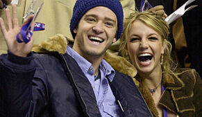 FILE - In this Feb. 10, 2002, file photo, Justin Timberlake and Britney Spears wave to the crowd prior to the start of the 2002 NBA All-Star game in Philadelphia. Timberlake told E! News on Sept. 13, 2016, that he's open to collaborating with Spears. Spears mentioned Timberlake last month in answering a question about who she would like to work with one day. (AP Photo/Chris Gardner, File)
