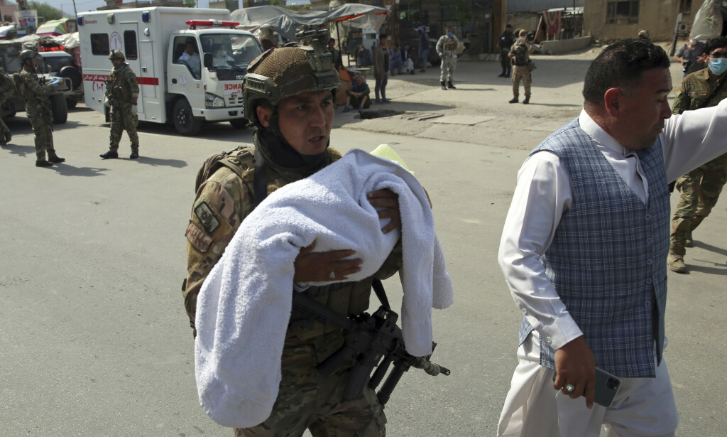 EVACUATED: More than 100 women and children were dramatically evacuated from the hospital while the attack was underway. The images show heavily armed soldiers with babies in their arms. Photo: AP Photo / Rahmat Yellow 